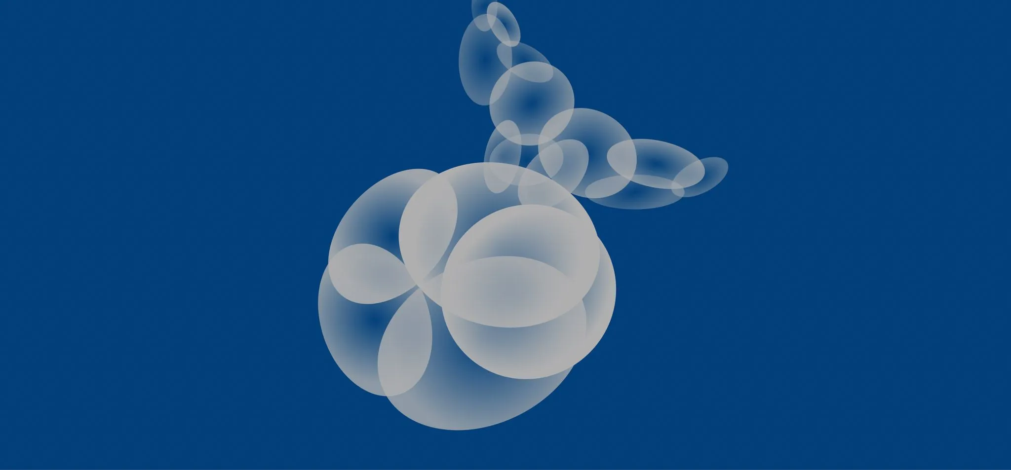 Imagem de bolhas cinzas formando a silhueta de uma baleia. O fundo da imagem é um azul sólido.