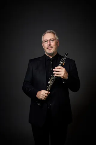 An oboe is a black wooden instrument similar to a clarinet.