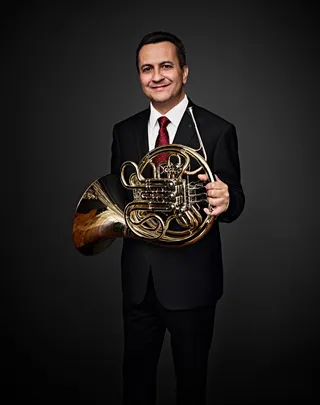 José Costa Filho is a white man with brown hair. He is wearing a navy blue blazer, a white shirt, and a red tie.